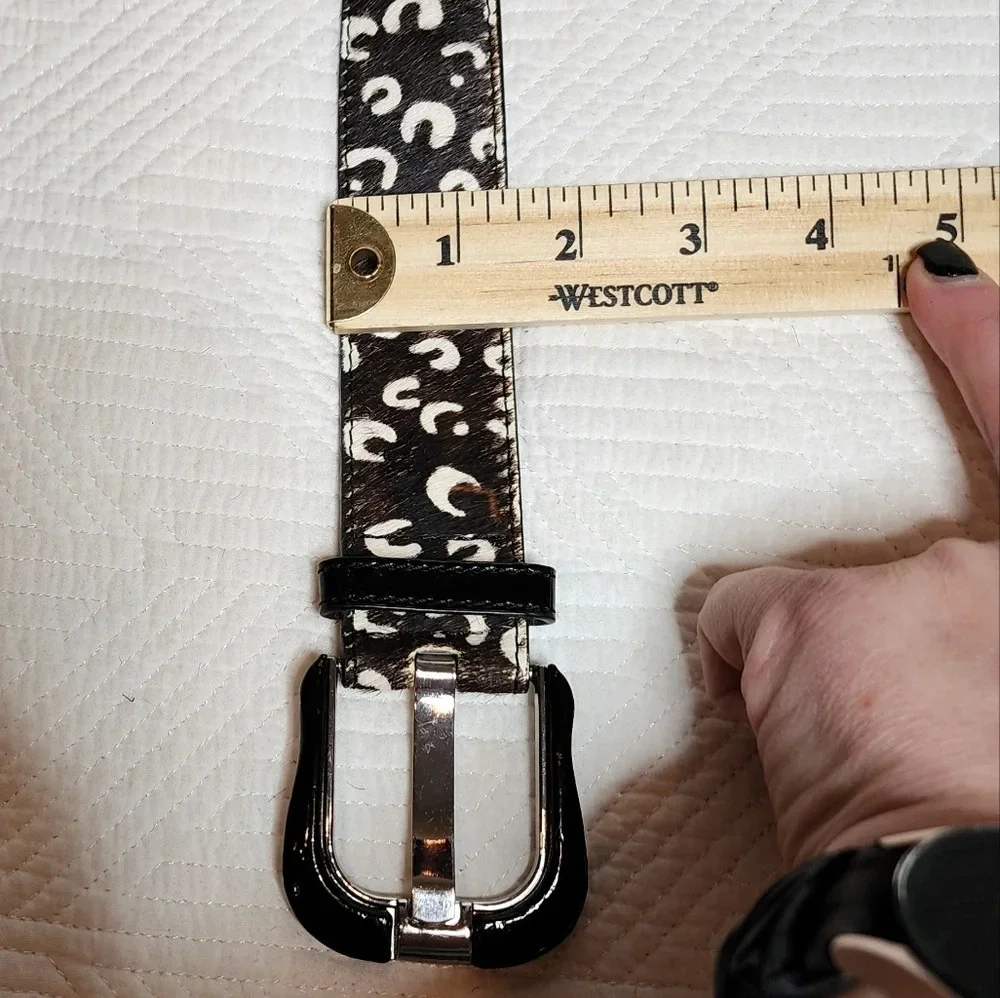 100% calf hair leather‎ dark brown, white spotted belt.